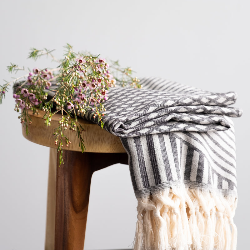 Aphrodite Turkish towel on the stool with a pink flower Urban Pera