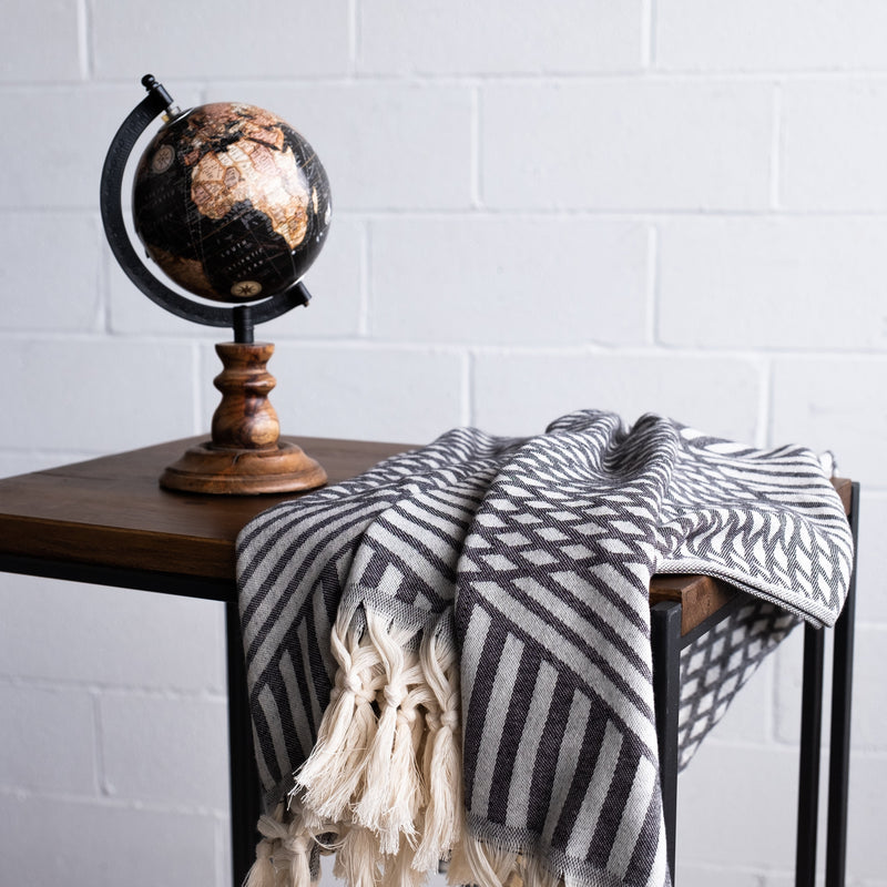 Aphrodite Turkish towel on the table beside a globe object Urban Pera